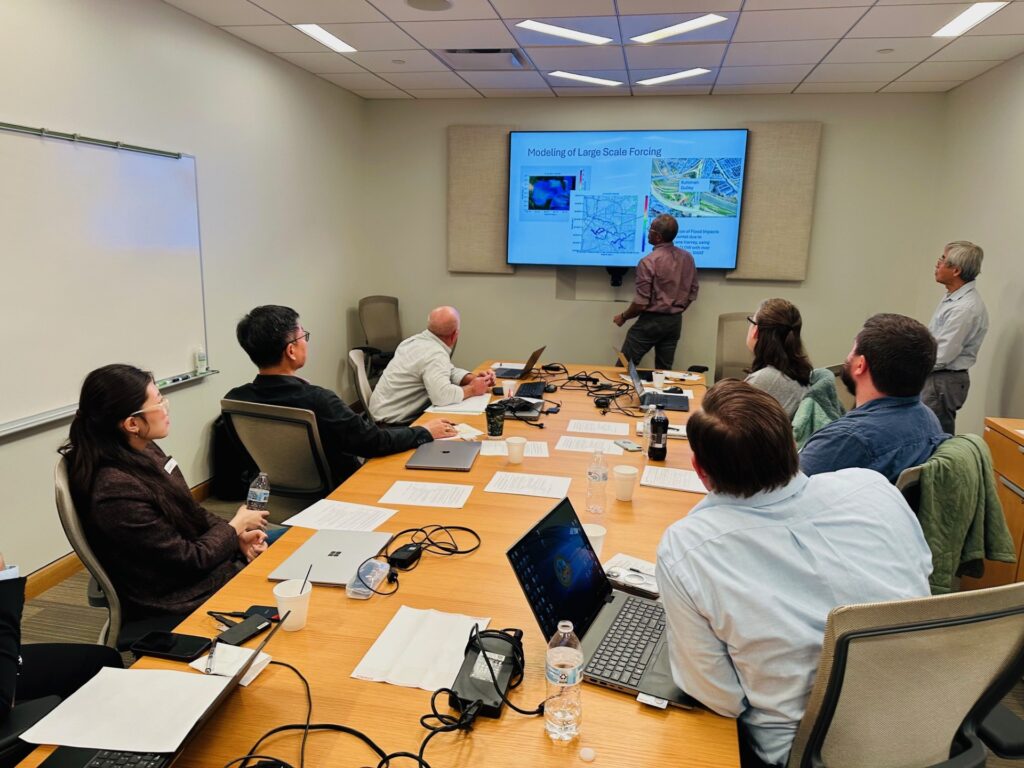 A group of people in a conference room attending a presentation